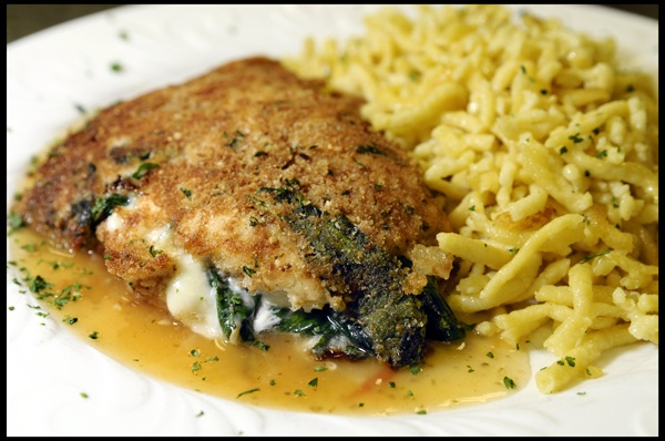 Chicken Breast with a Parmesan Oregano Bread Crust Filled with Fresh Spinach, Onions, Garlic andSwiss Cheese on a Tomato Oregano Sauce served with Spätzle