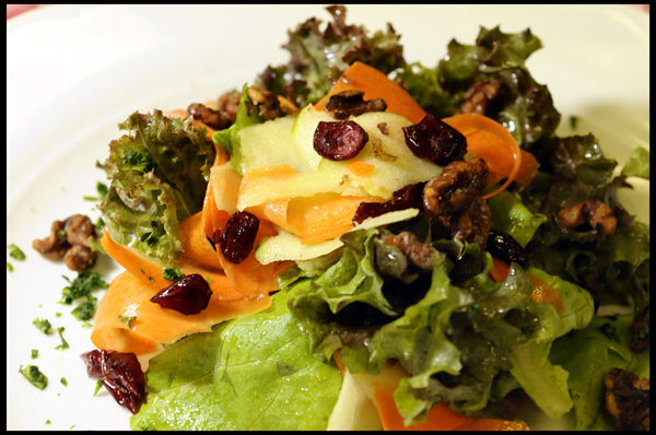 Mixed Salad Greens, shaved Granny Smith Apples, dried Cranberries, Carrots and Caramelized Walnuts tossed in a Champagne Vinaigrette 