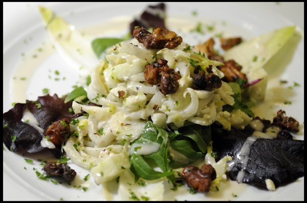 Sliced Endive Leaves, Granny Smith Apples, Caramelized Walnuts and Blue Cheese Crumbles tossed in a Home-Made Cream Vinaigrette garnished with Salad Greens.