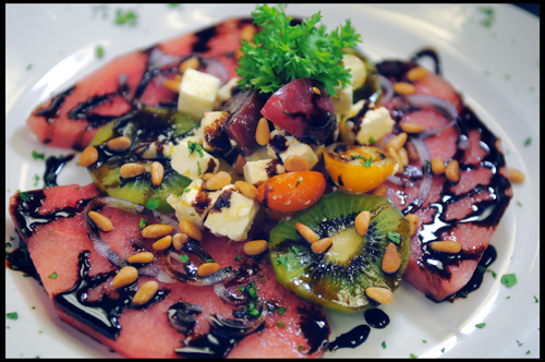 Watermelon Salad with Feta, Pine Nuts, Kiwi and drizzled with a Balsamic Reduction